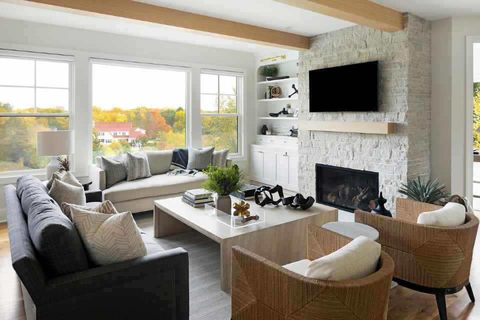 open concept living room with brick fireplace and exposed wood beams